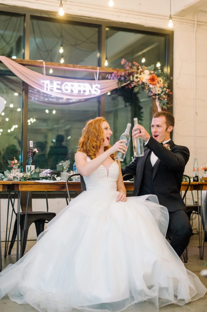Bride and groom toast at rainy fall wedding in Louisville KY